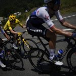 
              Denmark's Jonas Vingegaard, wearing the overall leader's yellow jersey, talks to riders of the Quick-Step Alpha Vinyl team trying to slow down the pace of the pack during the eighteenth stage of the Tour de France cycling race over 143.5 kilometers (89.2 miles) with start in Lourdes and finish in Hautacam, France, Thursday, July 21, 2022. (AP Photo/Daniel Cole)
            