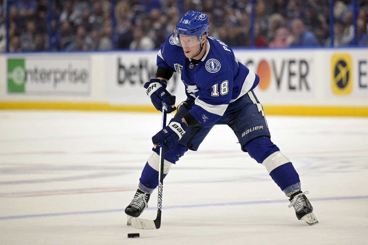 FILE - Tampa Bay Lightning left wing Ondrej Palat (18) controls a puck during the first period of G...