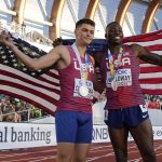 
              Gold medalist Grant Holloway, of the United States, right, poses with silver medalist Trey Cunningham, of the United States, after a final in the men's 110-meter hurdles the at the World Athletics Championships on Sunday, July 17, 2022, in Eugene, Ore. (AP Photo/Charlie Riedel)
            