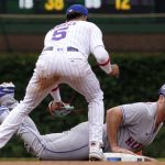 
              New York Mets' Pete Alonso, right, dives safely back to second base as Chicago Cubs second baseman Christopher Morel applies a late tag during the fourth inning in the first baseball game of a doubleheader in Chicago, Saturday, July 16, 2022. (AP Photo/Nam Y. Huh)
            