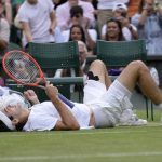 
              Taylor Fritz of the US lays on the court after falling trying to return to Spain's Rafael Nadal in a men's singles quarterfinal match on day ten of the Wimbledon tennis championships in London, Wednesday, July 6, 2022. (AP Photo/Kirsty Wigglesworth)
            