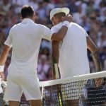 
              Serbia's Novak Djokovic, left, greets Australia's Nick Kyrgios at the net after beating him to win the final of the men's singles on day fourteen of the Wimbledon tennis championships in London, Sunday, July 10, 2022. (AP Photo/Alastair Grant)
            