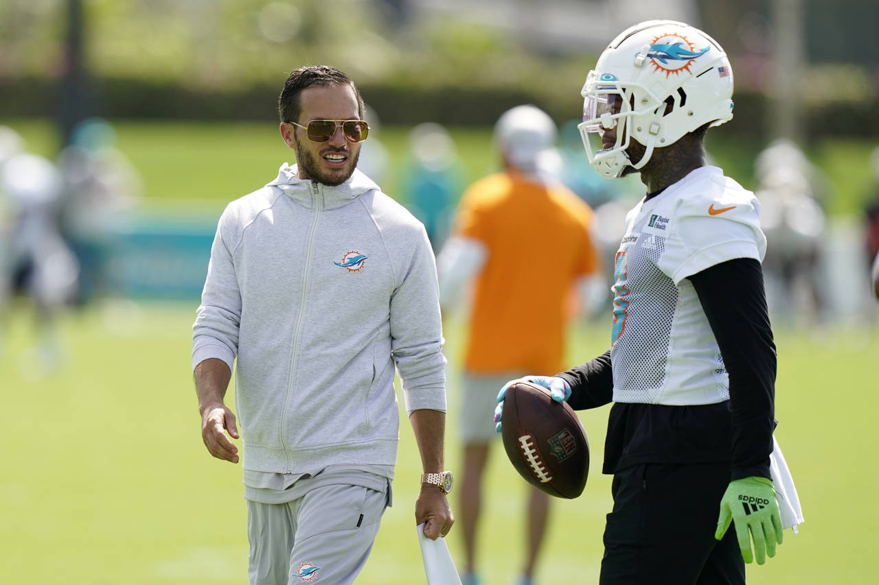 Miami Dolphins head coach Mike McDaniel, left, talks with wide receiver Lynn Bowden Jr., right, as ...