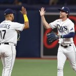 
              Tampa Bay Rays' Brett Phillips, right, celebrates with Issac Paredes after the team's win over the Boston Red Sox in a baseball game Wednesday, July 13, 2022, in St. Petersburg, Fla. (AP Photo/Scott Audette)
            