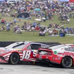 
              Kyle Busch (18) and Aric Almirola (10) spin out during a NASCAR Cup Series auto race Sunday, July 3, 2022, at Road America in Elkhart Lake, Wis. (AP Photo/Morry Gash)
            