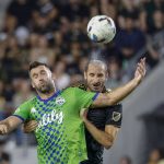 
              Los Angeles FC defender Giorgio Chiellini, right, and Seattle Sounders forward Will Bruin try to head the ball during the first half of an MLS soccer match Friday, July 29, 2022, in Los Angeles. (AP Photo/Ringo H.W. Chiu)
            