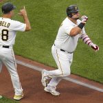 
              Pittsburgh Pirates' Daniel Vogelbach, right, celebrates with third base coach Mike Rabelo (58) as he rounds third after hitting a solo home run off New York Yankees starting pitcher Jameson Taillon during the second inning of a baseball game in Pittsburgh, Tuesday, July 5, 2022. (AP Photo/Gene J. Puskar)
            