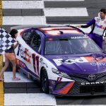 
              Taylor James Hamlin, left, carries the checker flag with her dad, Denny Hamlin after he won the NASCAR Cup Series auto race at Pocono Raceway, Sunday, July 24, 2022, in Long Pond, Pa. (AP Photo/Matt Slocum)
            
