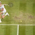 
              Italy's Jannik Sinner returns to Serbia's Novak Djokovic in a men's singles quarterfinal match on day nine of the Wimbledon tennis championships in London, Tuesday, July 5, 2022. (AP Photo/Alberto Pezzali)
            