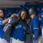 
              Toronto Blue Jays first baseman Vladimir Guerrero Jr. (27) celebrates with teammates after hitting a two-run home run during the first inning of a baseball game against the St. Louis Cardinals, Tuesday, July 26, 2022 in Toronto. (Christopher Katsarov/The Canadian Press via AP)
            
