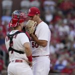 
              St. Louis Cardinals starting pitcher Adam Wainwright, right, talks with catcher Andrew Knizner during the third inning of a baseball game against the Los Angeles Dodgers Wednesday, July 13, 2022, in St. Louis. (AP Photo/Jeff Roberson)
            