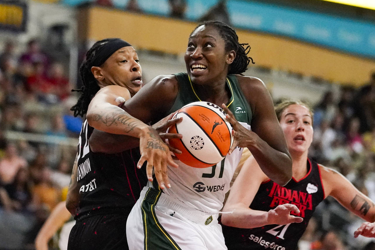 Seattle Storm center Tina Charles (31) gets tied up by Indiana Fever forward Emma Cannon (32) in th...