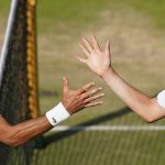 
              Serbia's Novak Djokovic, left, greets Britain's Cameron Norrie at the net after beating him in a men's singles semifinal on day twelve of the Wimbledon tennis championships in London, Friday, July 8, 2022. (AP Photo/Gerald Herbert)
            