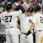 
              New York Yankees' Anthony Rizzo, center, and DJ LeMahieu, right, celebrate with Giancarlo Stanton, left, after they scored on a Stanton three-run home run during the third inning of the team's baseball game against the Boston Red Sox on Friday, July 15, 2022, in New York. (AP Photo/Frank Franklin II)
            