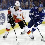 
              Calgary Flames left wing Johnny Gaudreau (13) carries the puck past Tampa Bay Lightning left wing Ondrej Palat (18) during the third period of an NHL hockey game, Jan. 11, 2018, in Tampa, Fla. Executives around the NHL expect plenty of movement before free agency opens Wednesday, July 13, 2022. Several top players including Gaudreau and Palat could still sign contracts prior to hitting the open market. (AP Photo/Chris O'Meara, file)
            