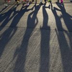 
              Runners cast shadows as they compete during the women's marathon at the World Athletics Championships Monday, July 18, 2022, in Eugene, Ore. (AP Photo/Charlie Riedel)
            