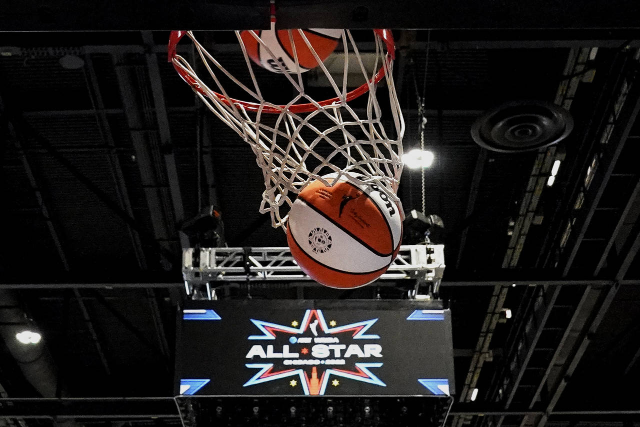 A ball goes through the basket during practice for the WNBA All-Star basketball game in Chicago, Sa...