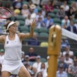 
              Germany's Tatjana Maria plays a return to Germany's Jule Niemeier in a women's singles quarterfinal match at the Wimbledon tennis championships in London, Tuesday July 5, 2022. (AP Photo/Kirsty Wigglesworth)
            