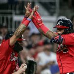 
              Atlanta Braves' Orlando Arcia, right, celebrates with a teammate after hitting a three-run home run against the Los Angeles Angels during the seventh inning of a baseball game Friday, July 22, 2022, in Atlanta. (AP Photo/Butch Dill)
            
