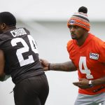
              Cleveland Browns quarterback Deshaun Watson (4) hands off to running back Nick Chubb (24) during the NFL football team's training camp, Wednesday, July 27, 2022, in Berea, Ohio. (AP Photo/Ron Schwane)
            