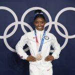 
              FILE - Simone Biles, of the United States, poses wearing her bronze medal from balance beam competition during artistic gymnastics at the 2020 Summer Olympics, Aug. 3, 2021, in Tokyo, Japan.  President Joe Biden will present the nation’s highest civilian honor, the Presidential Medal of Freedom, to 17 people, at the White House next week. (AP Photo/Natacha Pisarenko, File)
            