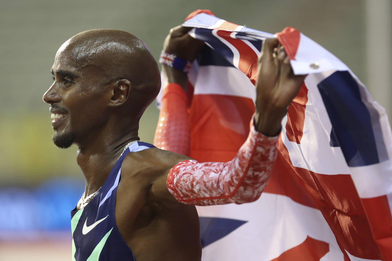 FILE - Britain's Mo Farah celebrates after winning the One Hour Men's race, at the Diamond League M...