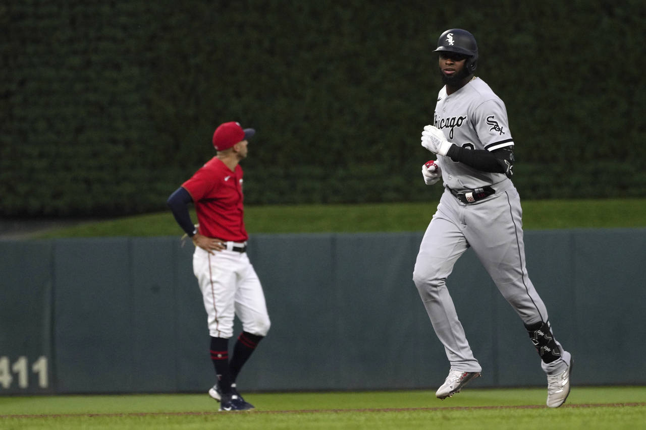 Chicago White Sox's Luis Robert, right, runs the bases on a grand slam off Minnesota Twins pitcher ...