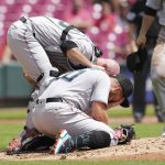
              Miami Marlins catcher Jacob Stallings, left, checks on starting pitcher Daniel Castano after he was hit by a line drive by Cincinnati Reds' Donovan Solano during the first inning of a baseball game Thursday, July 28, 2022, in Cincinnati. (AP Photo/Jeff Dean)
            