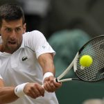 
              Serbia's Novak Djokovic returns to Italy's Jannik Sinner in a men's singles quarterfinal match on day nine of the Wimbledon tennis championships in London, Tuesday, July 5, 2022. (AP Photo/Alastair Grant)
            