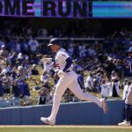 
              Los Angeles Dodgers' Freddie Freeman, left, rounds third after hitting a solo home run as Chicago Cubs third baseman Patrick Wisdom watches during the sixth inning of a baseball game Sunday, July 10, 2022, in Los Angeles. (AP Photo/Mark J. Terrill)
            