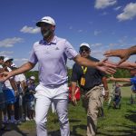 
              Dustin Johnson greets fans as he heads towards the 10th tee during the second round of the Bedminster Invitational LIV Golf tournament in Bedminster, N.J., Saturday, July 30, 2022. (AP Photo/Seth Wenig)
            