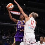 
              Los Angeles Sparks guard Brittney Sykes (15) drives to the basket against Washington Mystics forward Elena Delle Donne (11) during the first half of a WNBA basketball game Tuesday, July 12, 2022, in Los Angeles. (Keith Birmingham/The Orange County Register via AP)
            