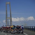 
              FILE - The pack rides over the Great Belt Bridge during the second stage of the Tour de France cycling race over 202.5 kilometers (125.8 miles) with start in Roskilde and finish in Nyborg, Denmark, Saturday, July 2, 2022. (AP Photo/Daniel Cole, File)
            