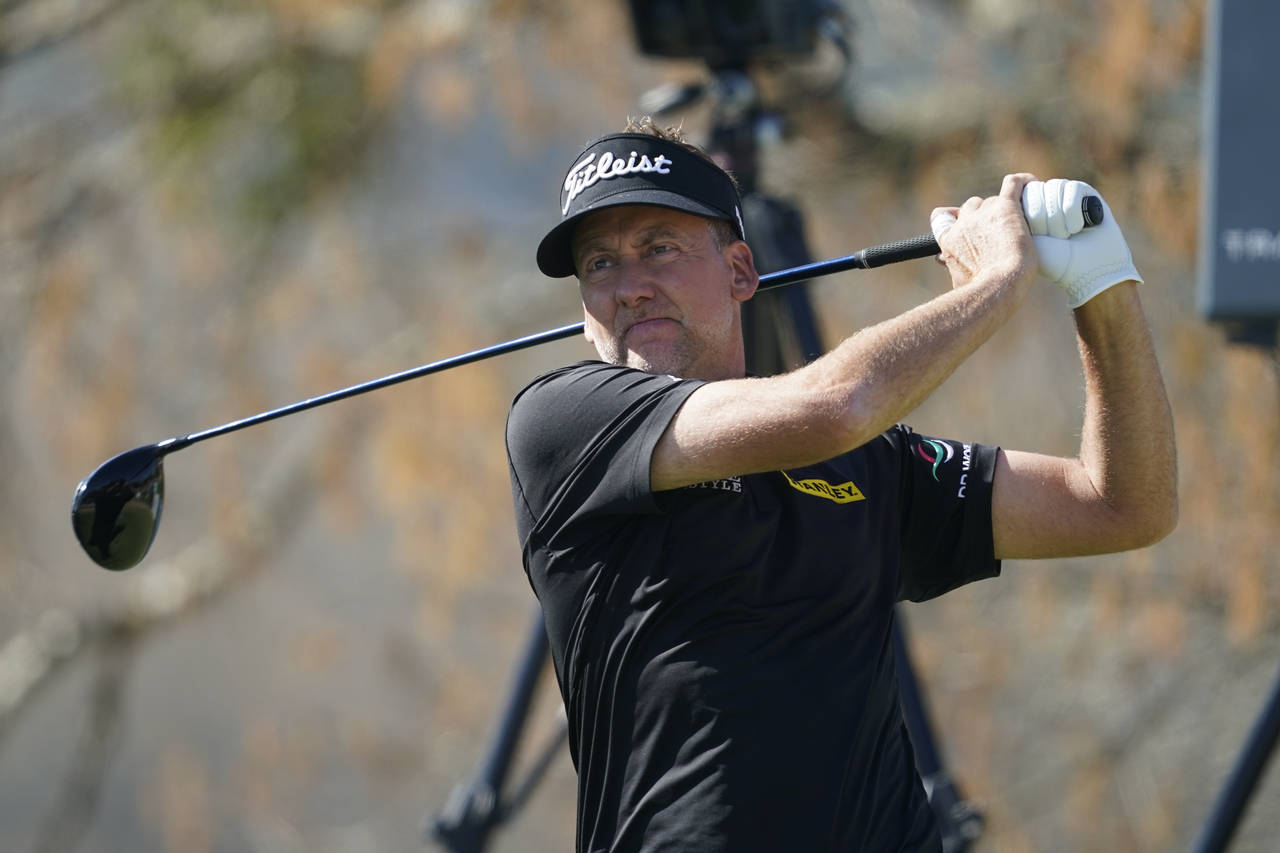 FILE - Ian Poulter watches his shot off the sixth tee during the third round of the Dell Technologi...