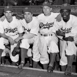 
              FILE - From left, Brooklyn Dodgers third baseman John Jorgensen, shortstop Pee Wee Reese, second baseman Ed Stanky, and first baseman Jackie Robinson pose before a baseball game against the Boston Braves at Ebbets Field in Brooklyn, N.Y., April 15, 1947. Already at the forefront on the 75th anniversary of breaking baseball’s color barrier, Jackie Robinson’s life, legacy and impact is honored as part of the 2022 baseball All-Star Game in Los Angeles. (AP Photo/Harry Harris, File)
            