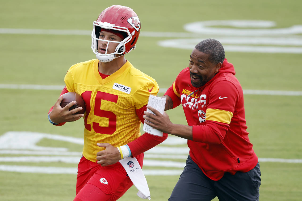 Kansas City Chiefs quarterback Patrick Mahomes (15) completes a running play as running backs coach...