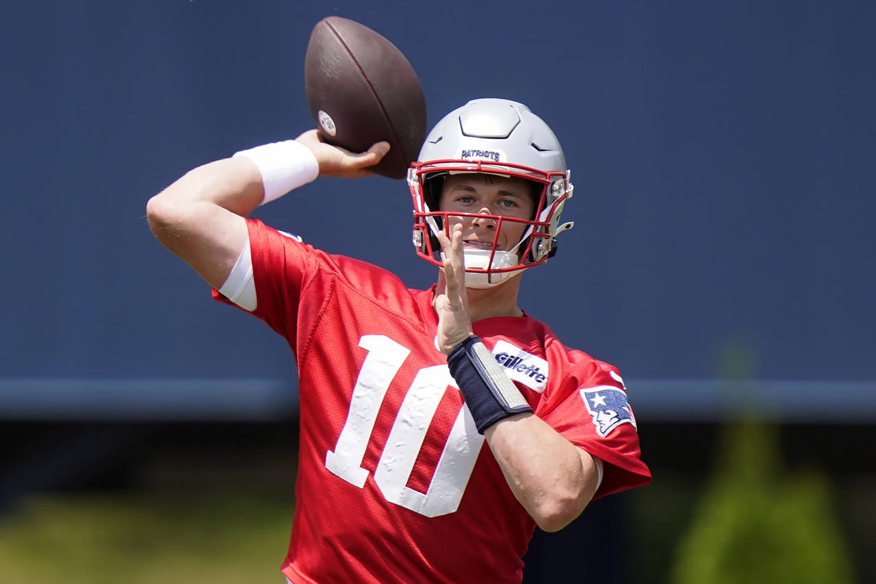 FILE - New England Patriots quarterback Mac Jones takes part in drills at the NFL football team's p...