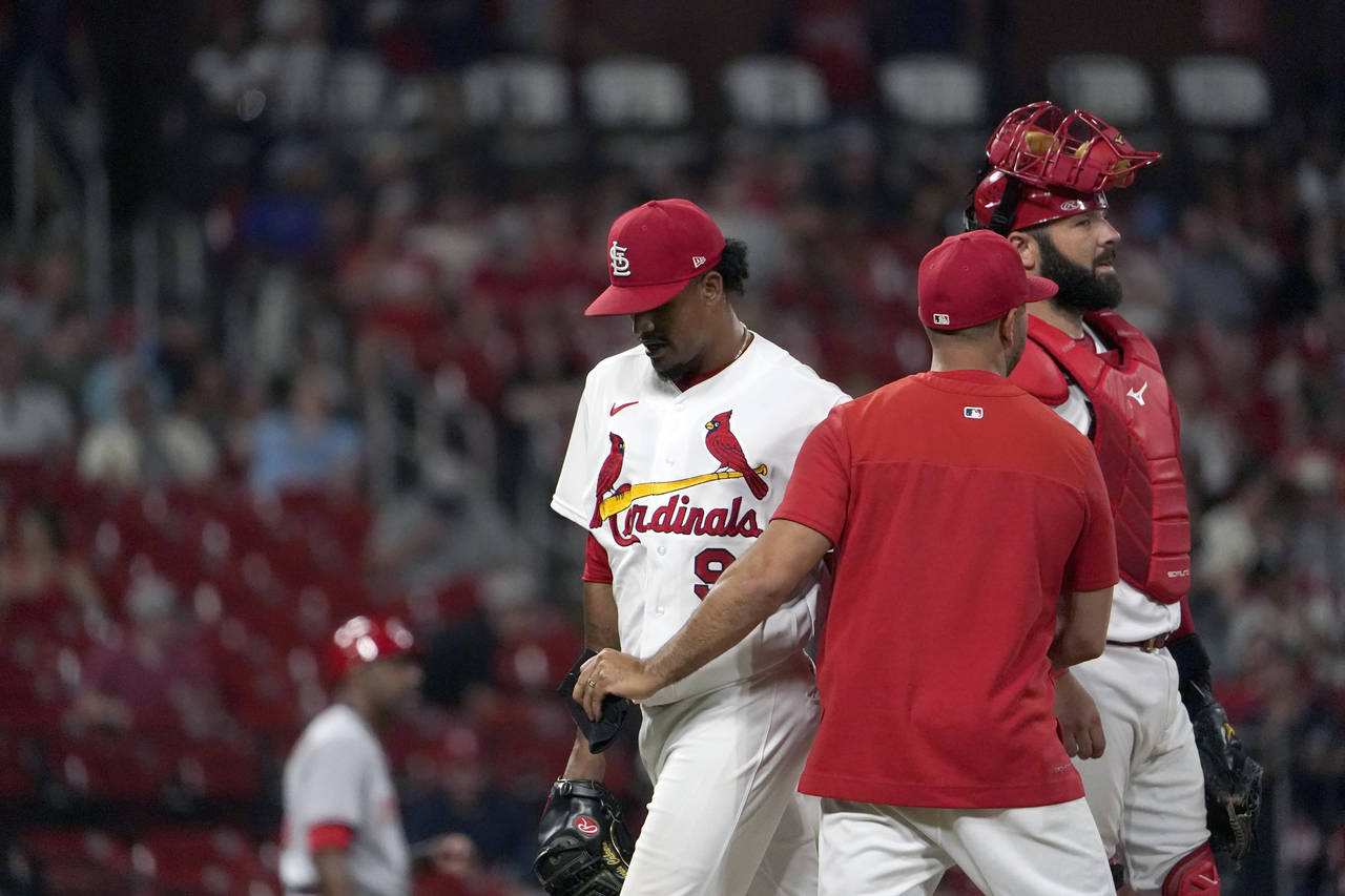 St. Louis Cardinals relief pitcher Genesis Cabrera, left, is removed by manager Oliver Marmol as ca...
