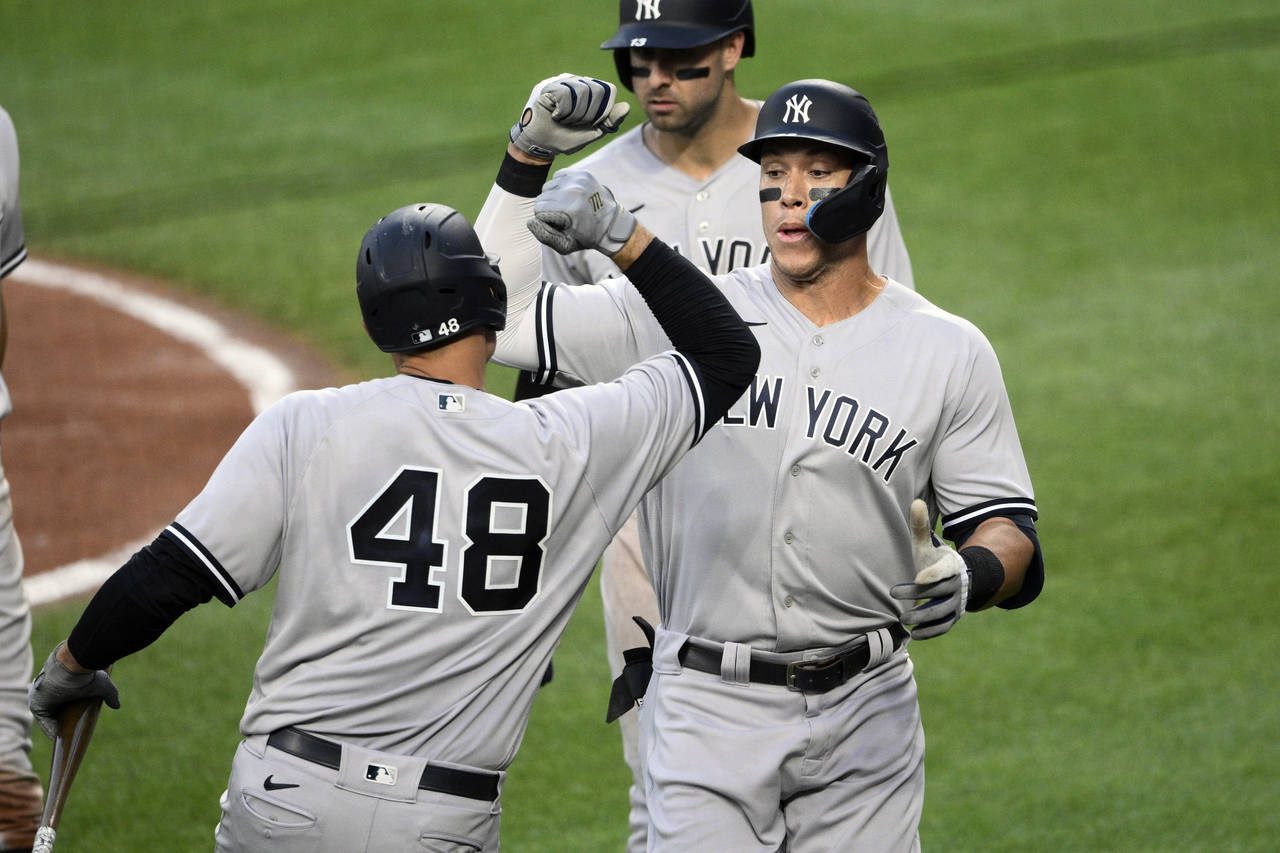 New York Yankees' Aaron Judge, right, celebrates his three-run home run with Anthony Rizzo (48) dur...