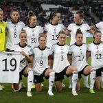 
              Germany players pose, with the jersey of teammate Klara Buehl, before the Women Euro 2022 semifinal soccer match between Germany and France at Stadium MK in Milton Keynes, England, Wednesday, July 27, 2022. Buehl is unable to play due to having been infected with COVID-19. (AP Photo/Alessandra Tarantino)
            