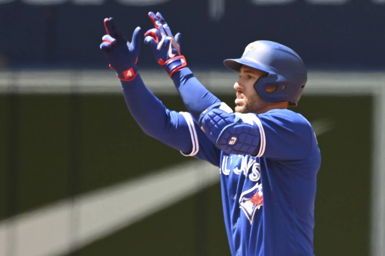 Toronto Blue Jays designated hitter George Springer motions to the dugout after hitting a double in...