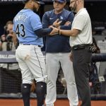 
              Tampa Bay Rays manager Kevin Cash, center, and head trainer Joe Being, right, check out Harold Ramirez after he was hit by a pitch by Baltimore Orioles starter Jordan Lyles during the first inning of a baseball game Sunday, July 17, 2022, in St. Petersburg, Fla. (AP Photo/Steve Nesius)
            