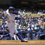 
              Los Angeles Dodgers' Mookie Betts hits a double during the first inning of a baseball game against the San Diego Padres Sunday, July 3, 2022, in Los Angeles. (AP Photo/Mark J. Terrill)
            