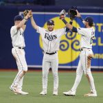 
              Tampa Bay Rays right fielder Brett Phillips, center, celebrates with teammates Luke Raley, left, and Josh Lowe after defeating the Boston Red Sox in a baseball game Monday, July 11, 2022, in St. Petersburg, Fla. (AP Photo/Scott Audette)
            