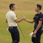 
              Rory McIlroy of Northern Ireland, left, and Viktor Hovland, of Norway, shake hands on the 18th green after finishing their final round of the British Open golf championship on the Old Course at St. Andrews, Scotland, Sunday July 17, 2022. (AP Photo/Gerald Herbert)
            