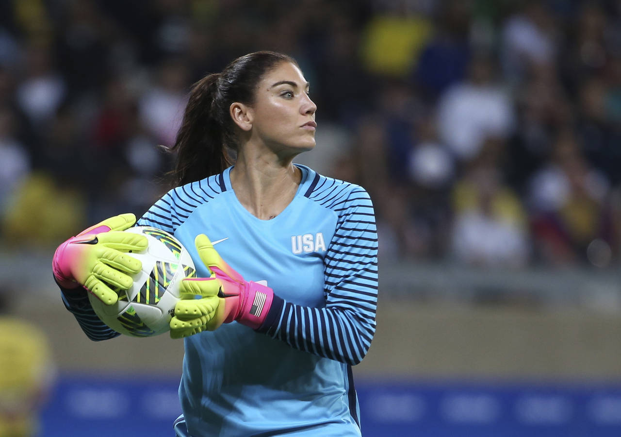 FILE - United States goalkeeper Hope Solo takes the ball during a women's soccer game at the Rio Ol...