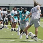 
              Miami Dolphins offensive lineman Blaise Andries (71) cheers with defensive tackle John Jenkins (77) at the start of drills at the NFL football team's practice facility, Saturday, July 30, 2022, in Miami Gardens, Fla. (AP Photo/Marta Lavandier)
            
