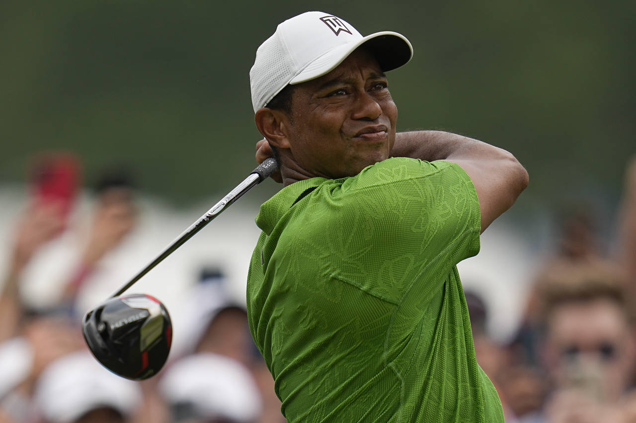 FILE - Tiger Woods watches his tee shot on the second hole during the second round of the PGA Champ...