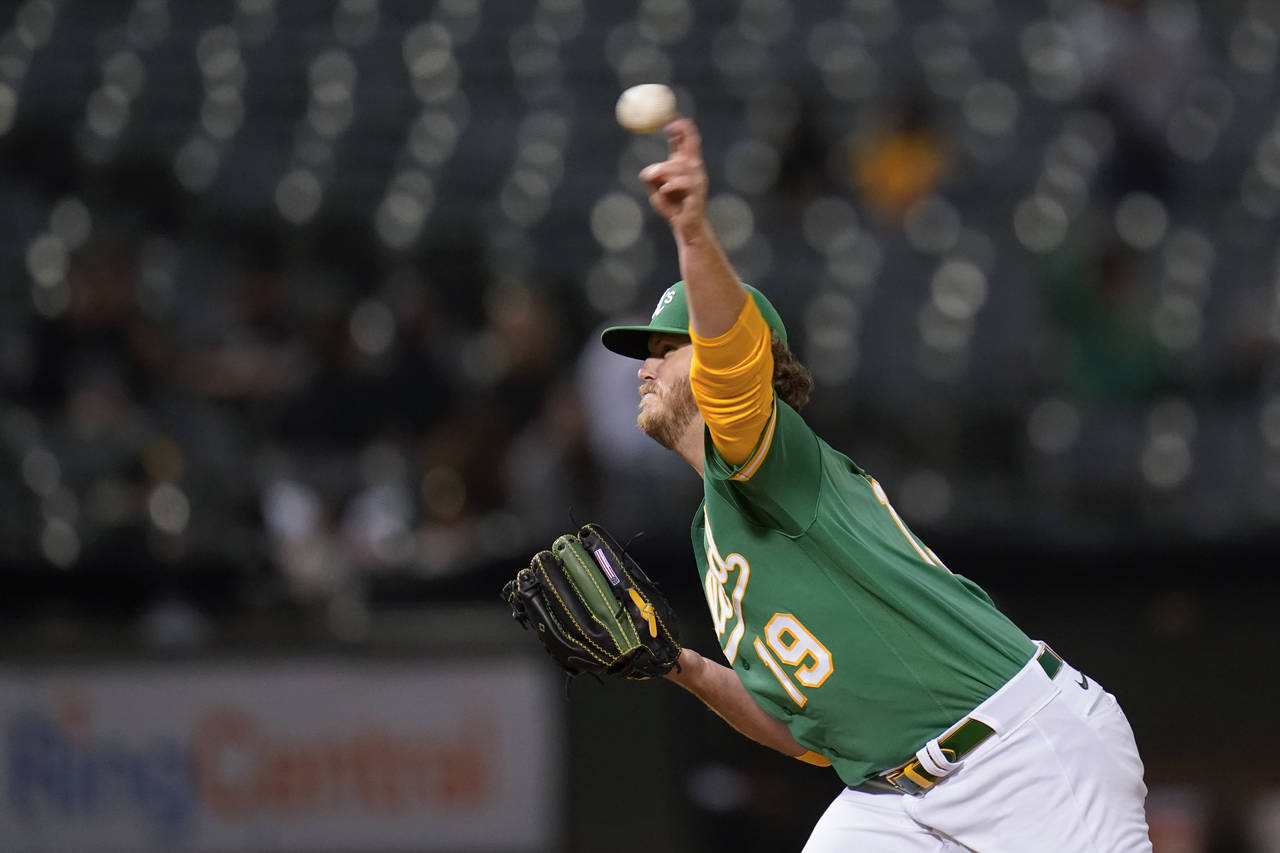 Oakland Athletics' Cole Irvin pitches against the Texas Rangers during the seventh inning of a base...