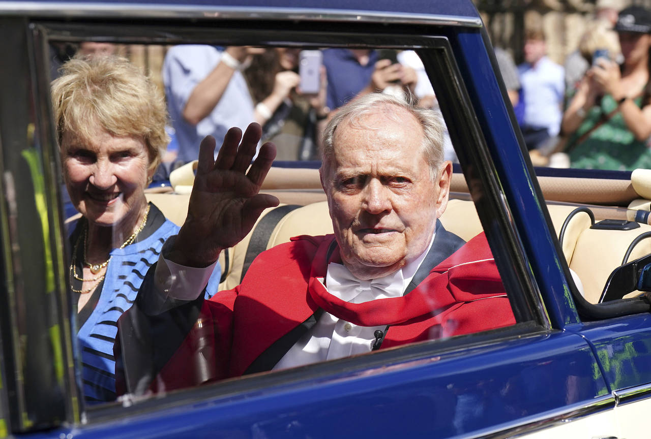 Three-time Open winner Jack Nicklaus from the United States with his wife Barbara Nicklaus, waves t...